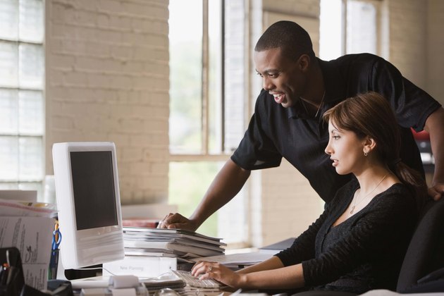 Businesspeople working at desktop computer