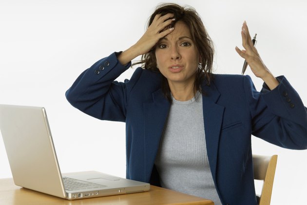 Extremely frustrated businesswoman with laptop
