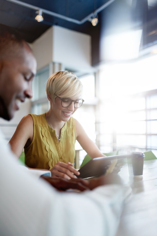 Two creative millenial small business owners working on social media