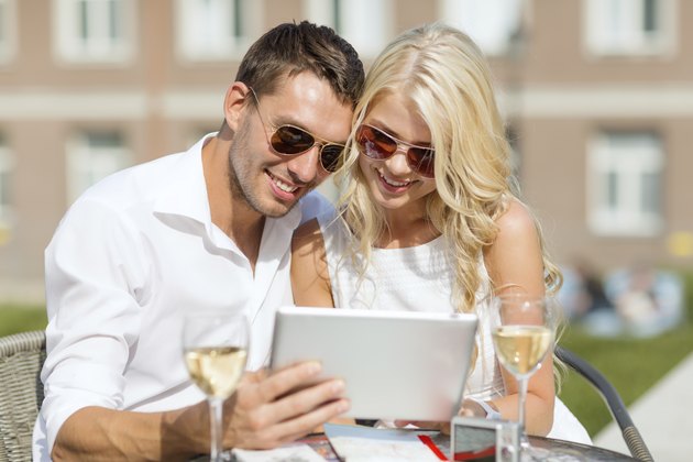 couple looking at tablet pc in cafe