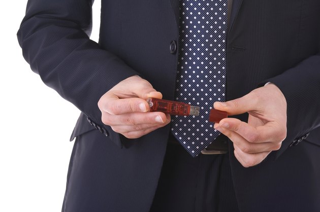 USB flash drive in Businessman hands.