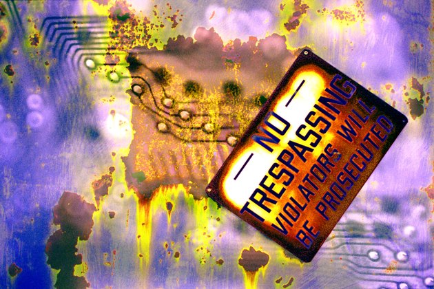 Rusted no trespassing sign with circuit board