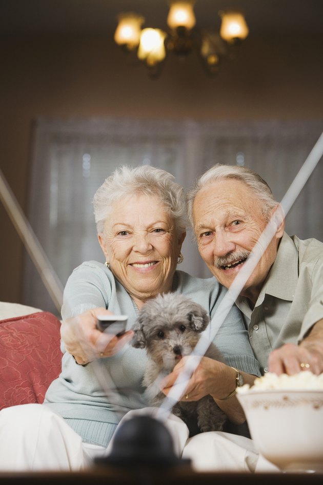 Senior couple watching television