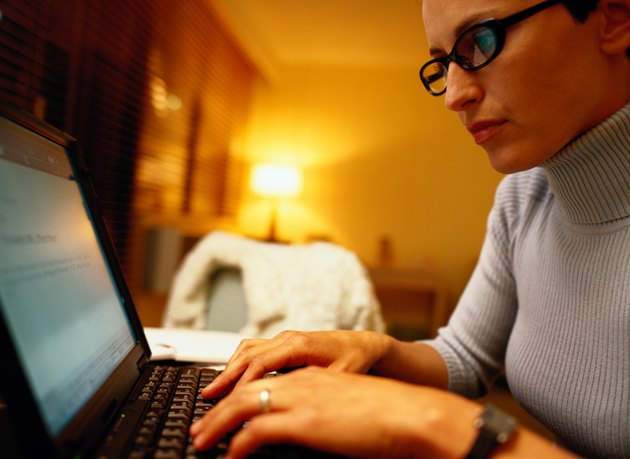 Woman Using Laptop at Home