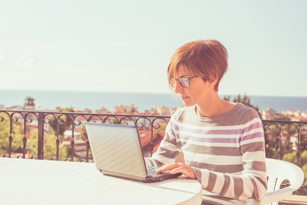 Woman working at home with netbook outdoors