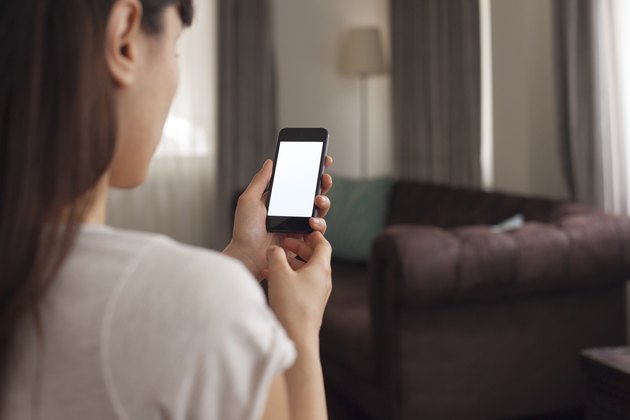 Woman using a smartphone in a living room