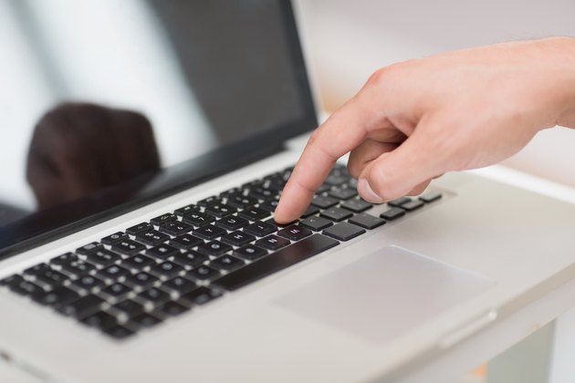 Hans hand using laptop keyboard