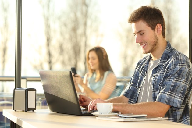 Man working with a laptop in coffee shop