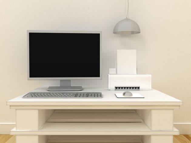 Empty PC computer monitor with printer on table