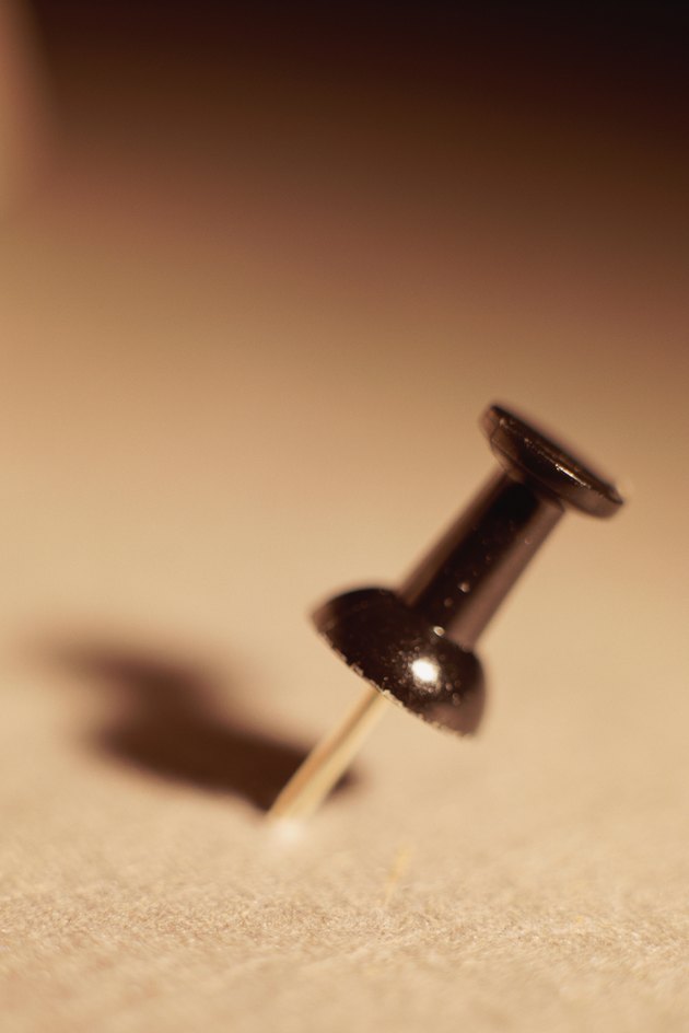 Push pin in bulletin board, close-up