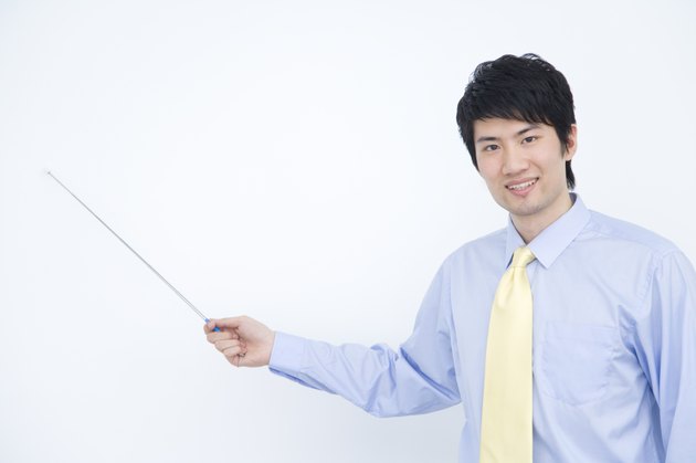 Portrait of businessman holding pointer stick, China, Beijing