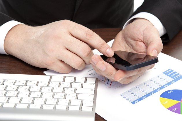 businessman in the office with graphics holding a phone
