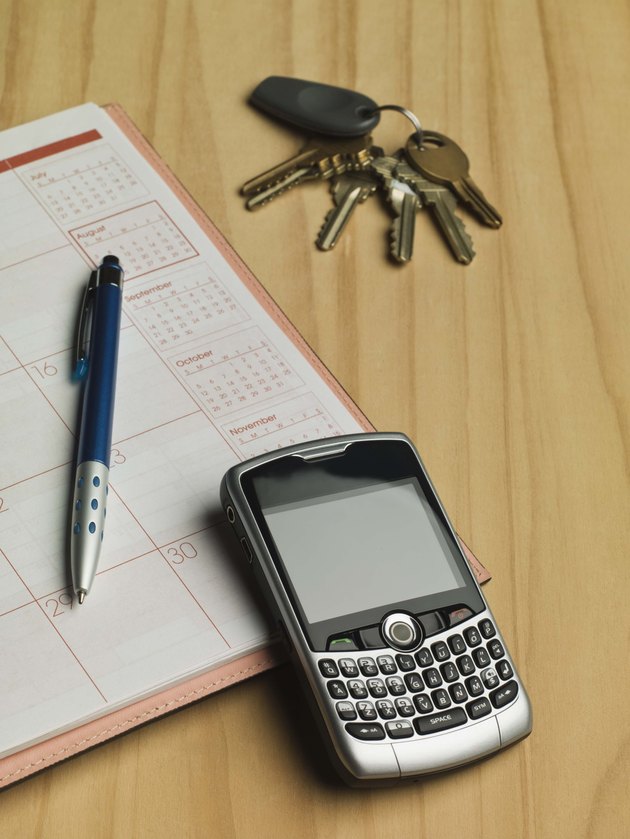 Cell phone and keys by appointment book and pen