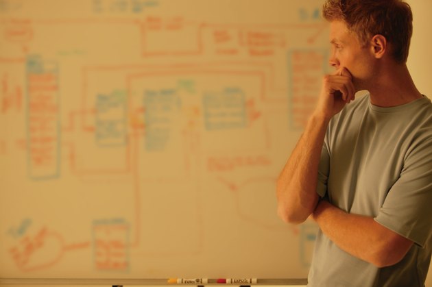 Man analyzes workflow chart