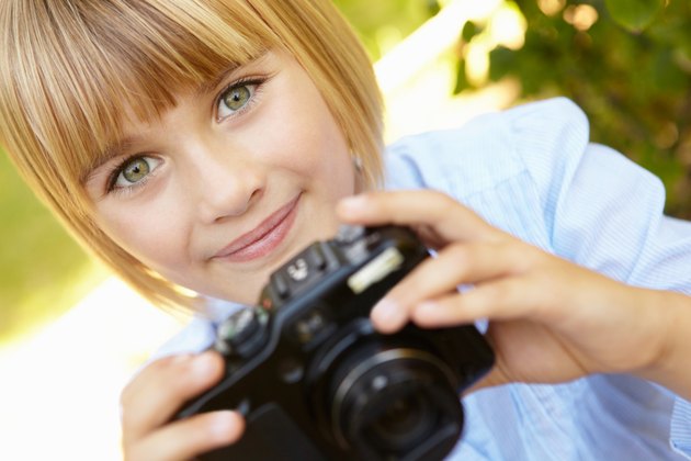 Young girl holding camera