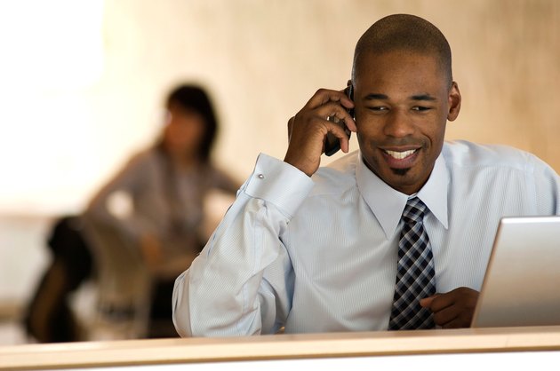 African-american businessman talking on PDA smart phone.