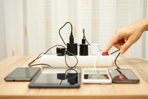 man is turning off power adapters for mobile phones