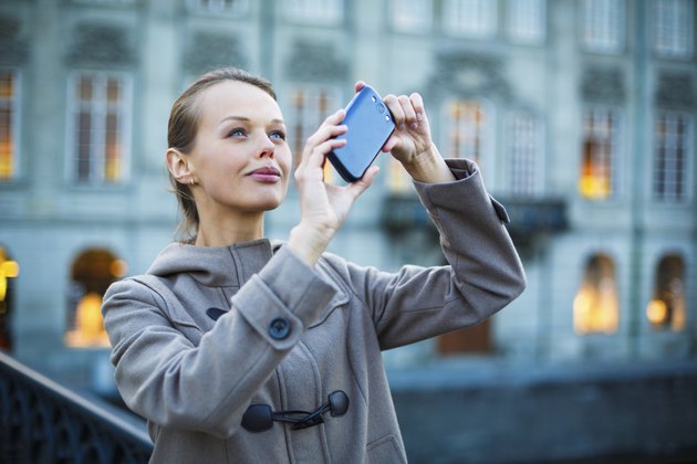 Elegant, young woman taking a photo