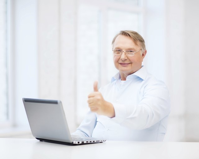 old man with laptop computer showing thumbs up