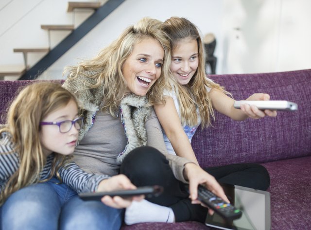 Family changing channels on the television