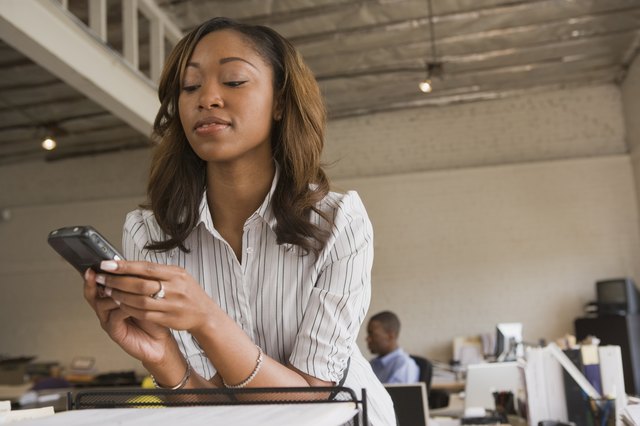 Woman text messaging on cellular phone