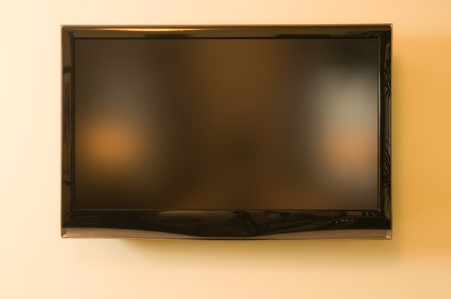 Television hanging on wall