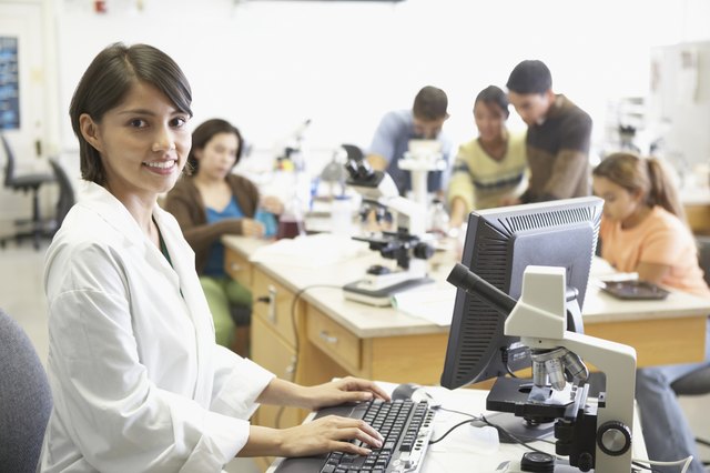 Portrait of a lab technician in front of a computer monitor