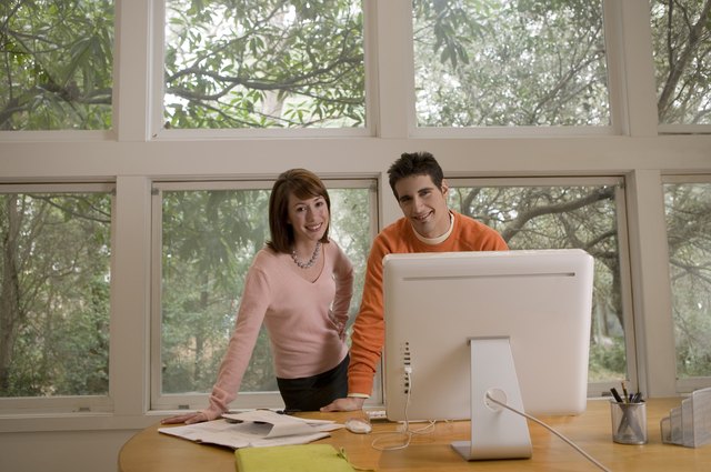 Man and woman in front of computer