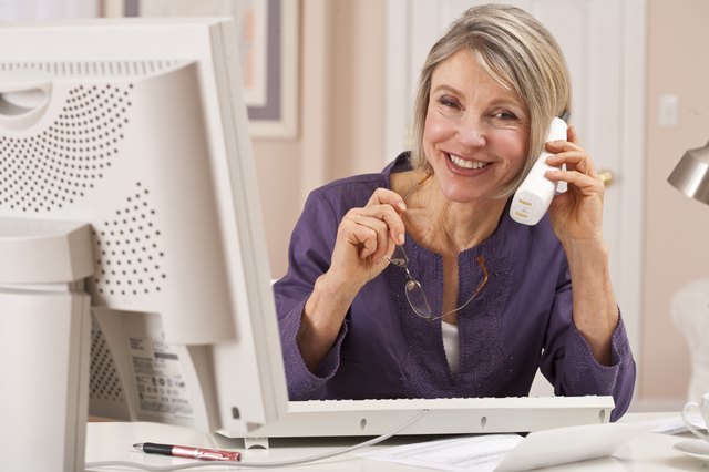 woman on phone on computer