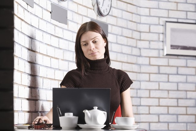 Young woman using laptop in cafe