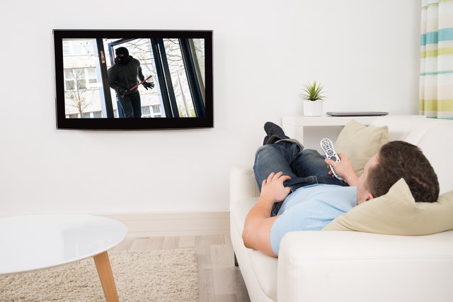 Man Watching Movie On Television In Living Room