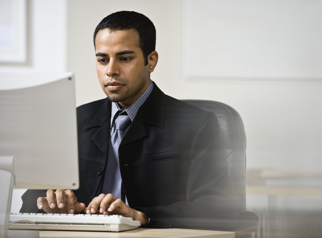 Indian businessman typing on computer