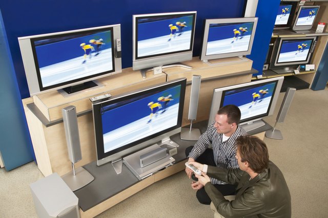 Salesman and male customer looking at television, overhead view
