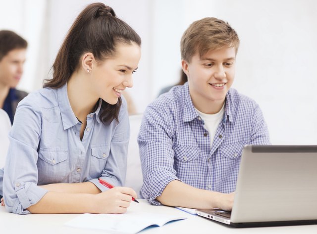 students with laptop and notebooks at school