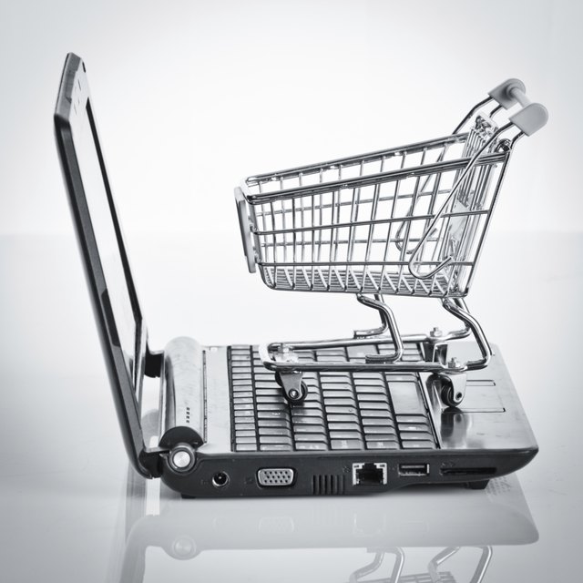 Online shopping. Shopping cart with notebook on the white. shopp