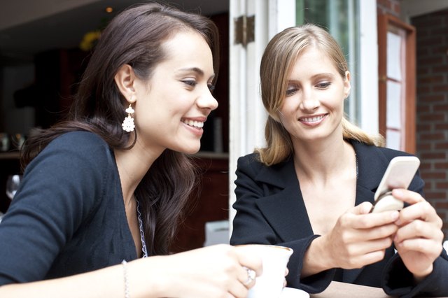 friends using smart phone at coffee shop