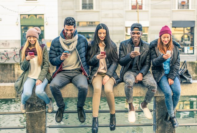 Multiracial group of people with cellphones