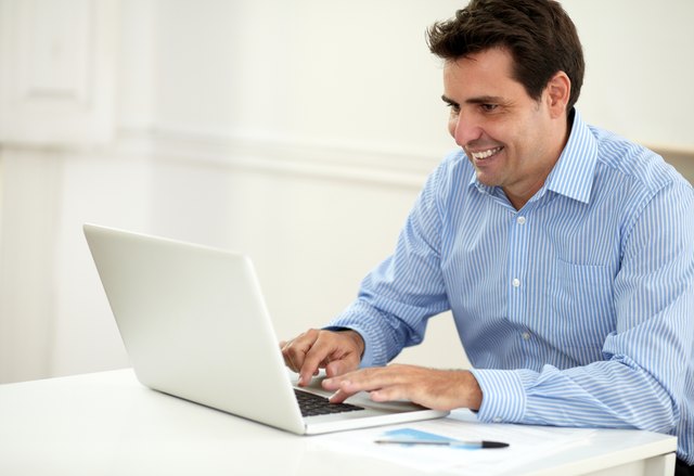 Attractive male entrepreneur working on his laptop