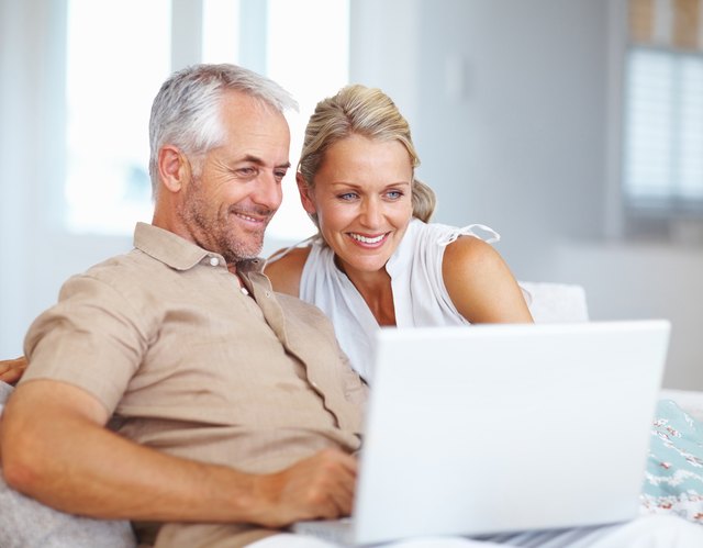 Mature couple using laptop at home