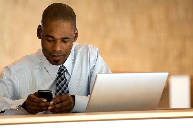 African-american businessman working on PDA.