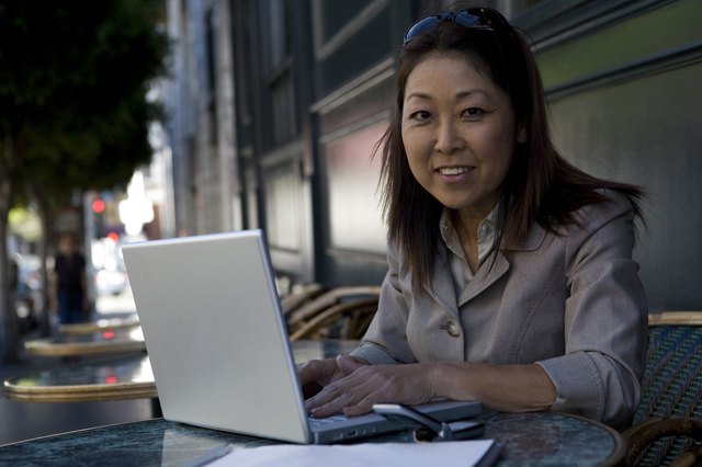 Portrait of businesswoman using laptop and smiling