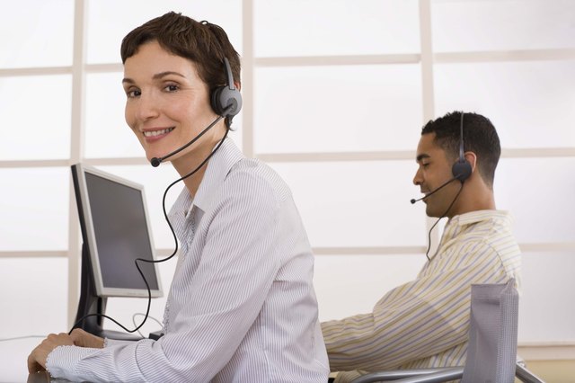 Businesspeople using handsfree headset telephone