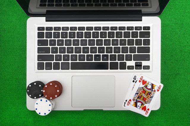 Laptop, poker cards and poker chips