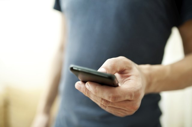 Close up of a man using mobile smart phone