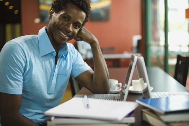 Smiling man with laptop computer