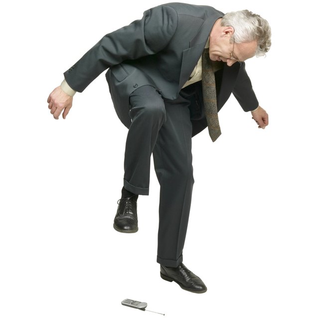 Frustrated Businessman Stepping On Cell Phone