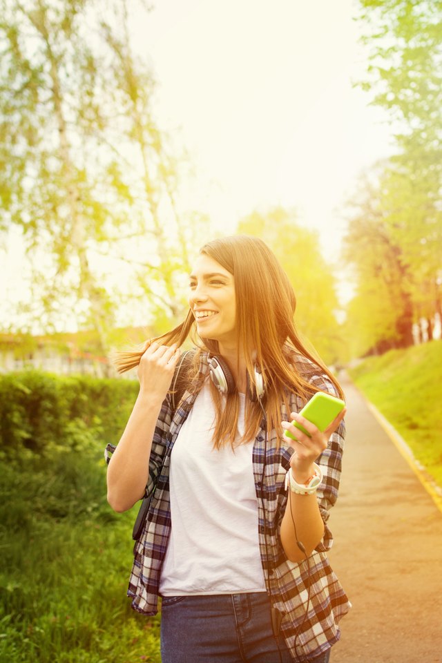 Happy young woman with smartphone