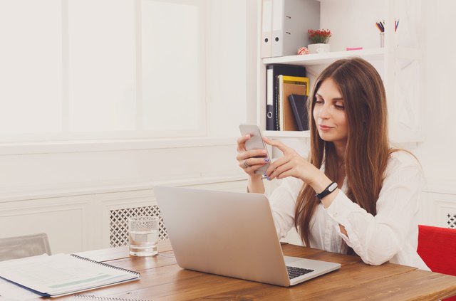 Beautiful young businesswoman making a call by mobile phone